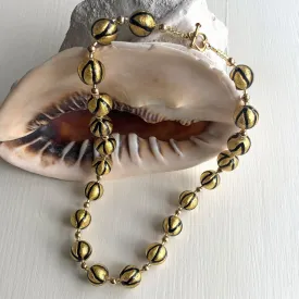 Necklace with black pastel drizzle and gold Murano glass small sphere beads on gold