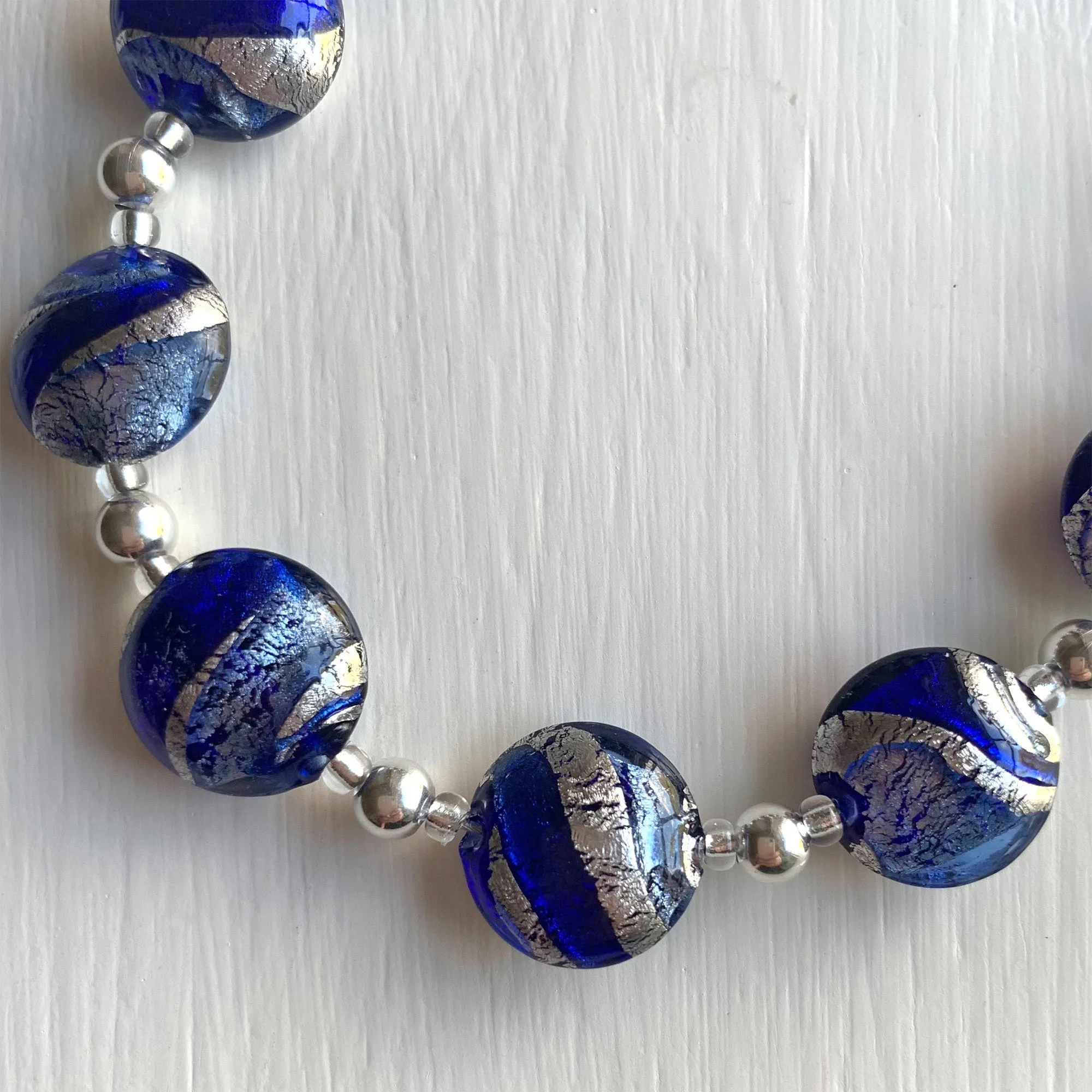 Necklace with dark blue and cornflower swirl over white gold Murano glass small lentil beads on silver